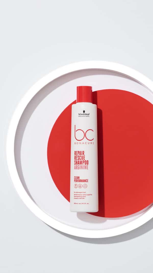 Shampoo repair rescue de Shawrkopz sobre un fondo con un circulo rojo, blanco y gris.