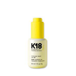 Botella de aceite capilar K18 Molecular Repair de 30 ml con dispensador amarillo sobre fondo blanco. El envase es blanco con letras negras y detalles amarillos.